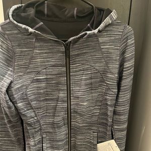 Never worn! New with tags. Lululemon sweater with black and white stripes.